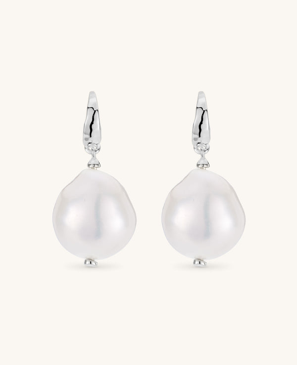 Pearl earrings with silver hooks on a white background