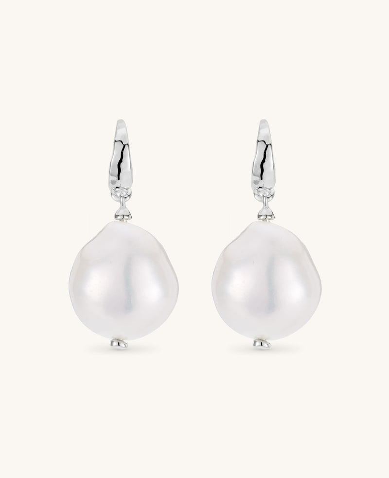 Pearl earrings with silver hooks on a white background