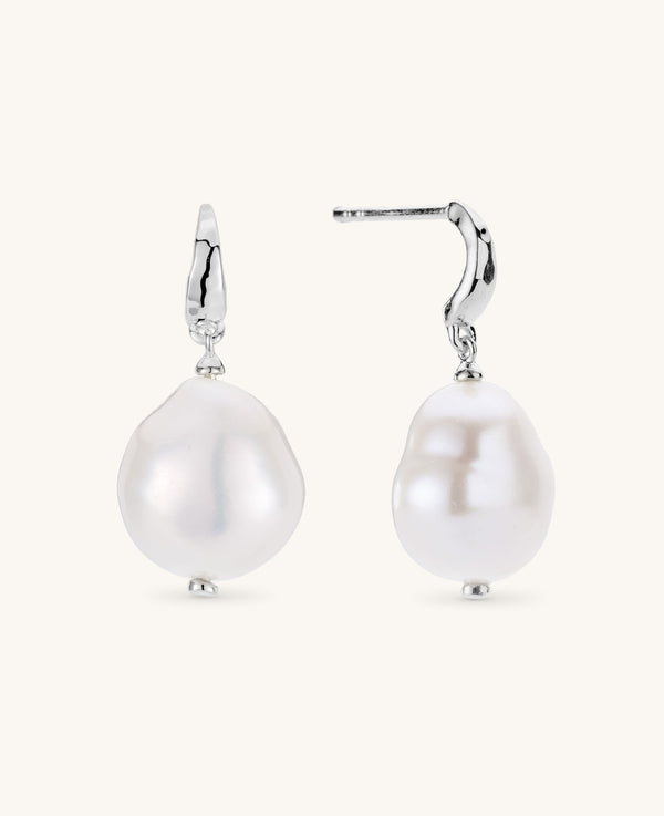 Pearl earrings with silver hooks on a white background