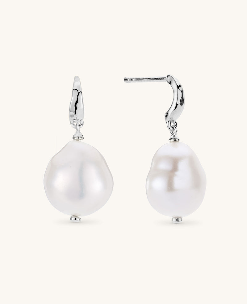 Pearl earrings with silver hooks on a white background