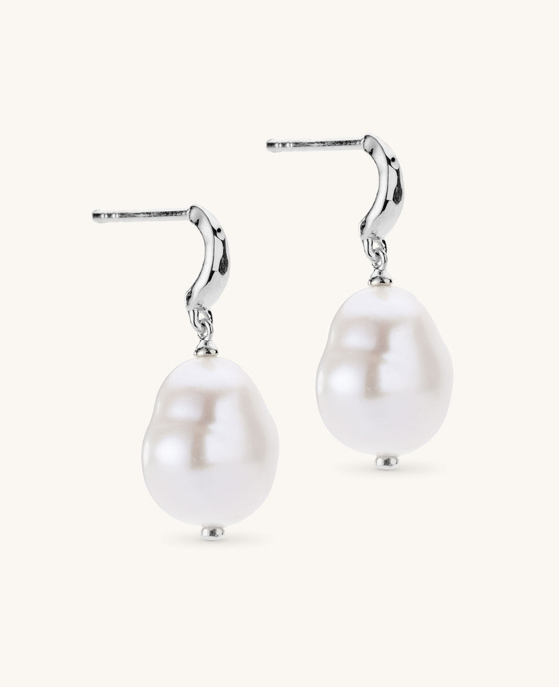 Pearl earrings with silver hooks on a white background