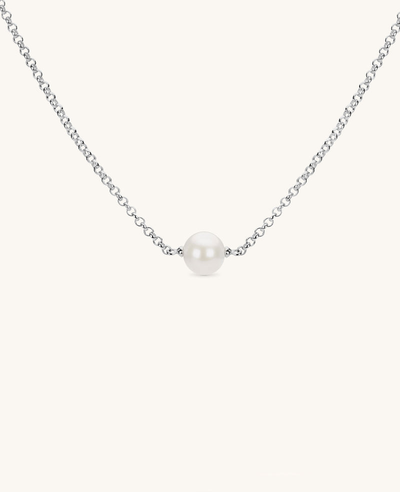 small single round pearl necklace on silver chain on white background
