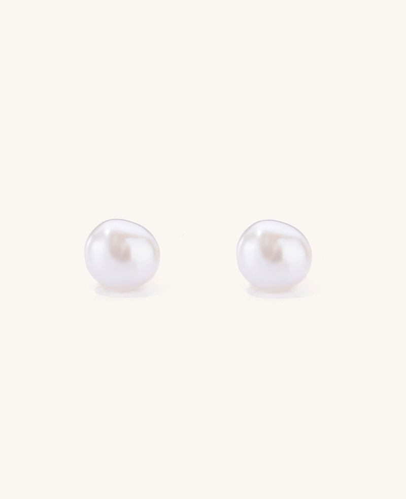 Pair of pearl stud earrings on a white background
